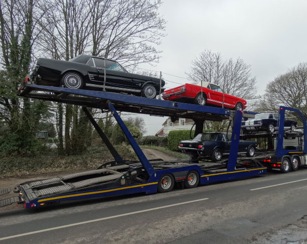 classic cars on vehicle transporter